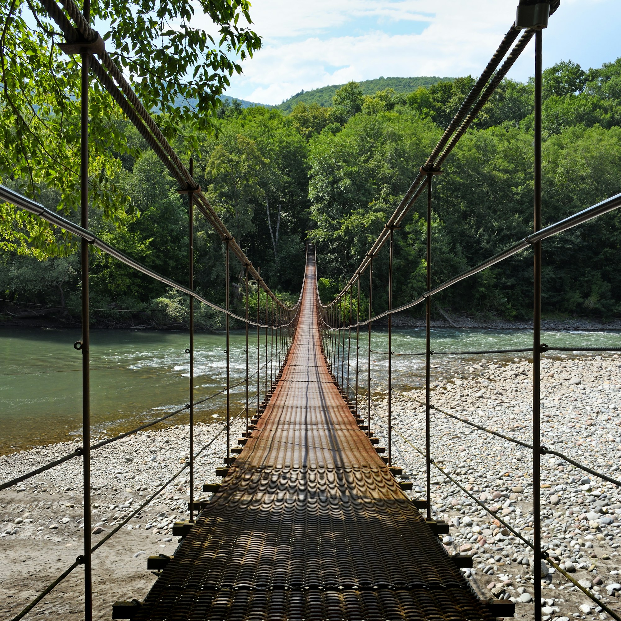 Suspension bridge through river Belaya in Republic of Adygea, Russia