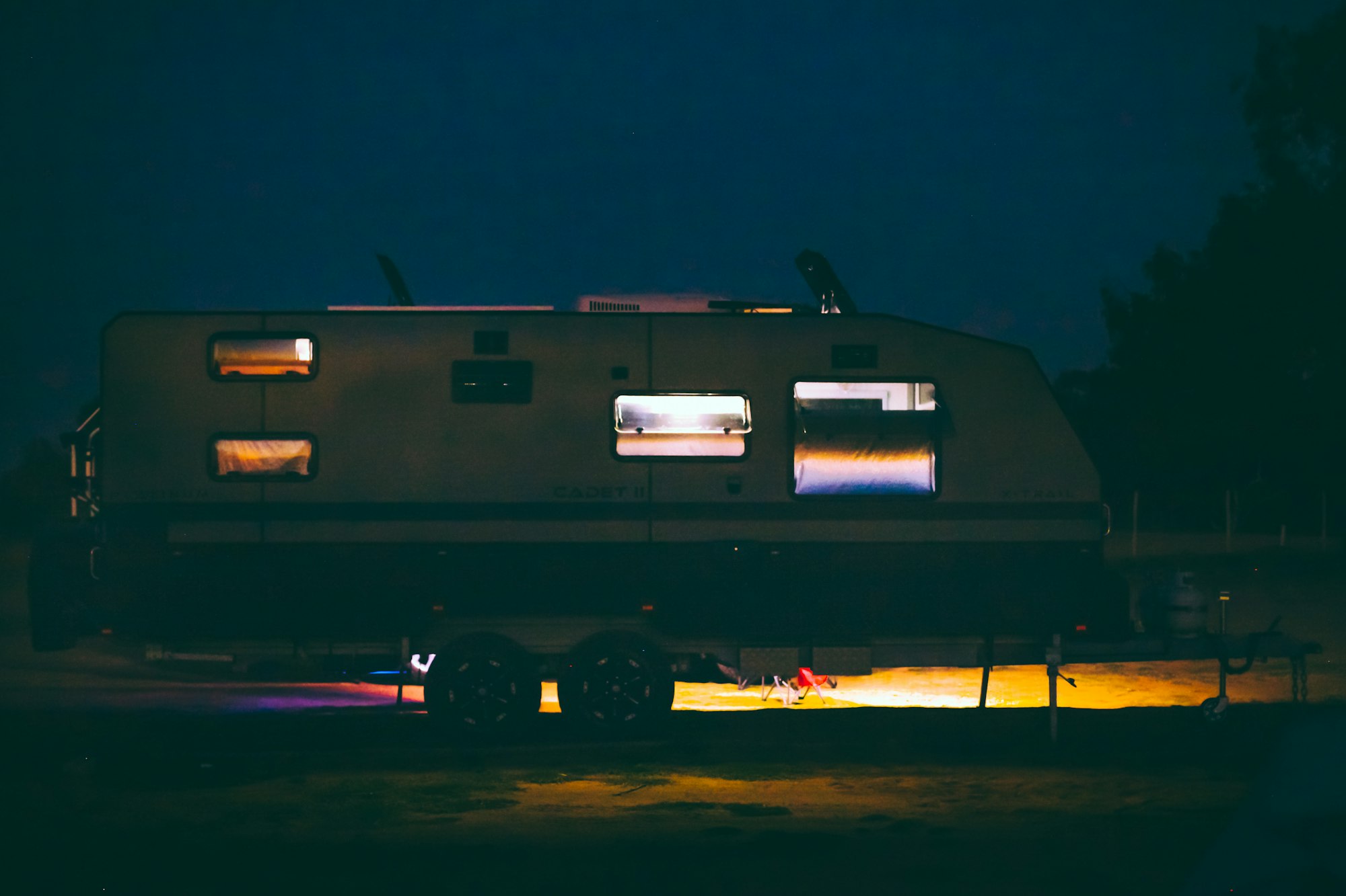 Travel trailer, caravan at campsite at night